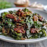 A steaming pot of soul food collard greens with smoked turkey and onions, rich in savory Southern flavor.