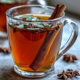 Golden dandelion root tea with ginger and turmeric, a warming, earthy herbal infusion in a rustic mug.