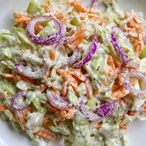 Close-up of a refreshing coleslaw salad, a perfect side dish for sandwiches or burgers.