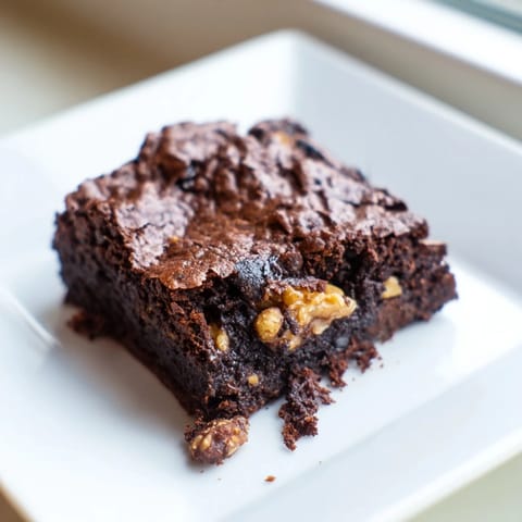 Warm, gooey brownies, perfectly cut, ready to be served and enjoyed after baking.