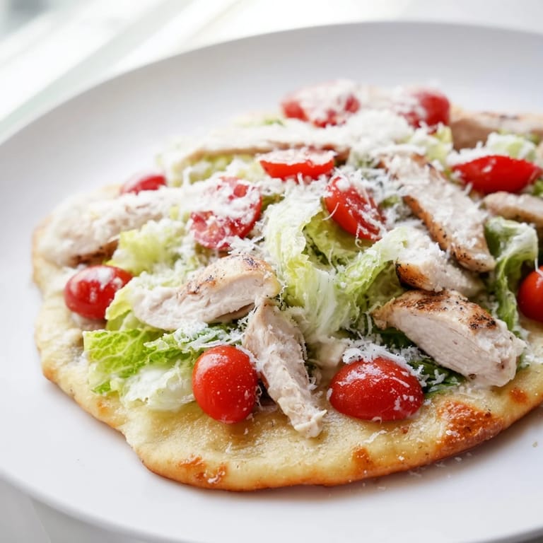 Sliced Chicken Caesar Flatbread on a rustic wooden board, perfect for a shareable appetizer or game-day snack.