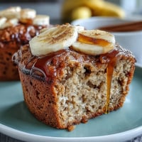 High-protein banana bread muffins baked golden and topped with chopped walnuts, perfect for meal prep breakfasts.  
