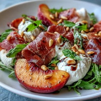 Vibrant Peach Burrata Prosciutto Salad with glistening balsamic glaze.